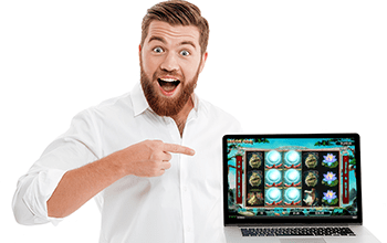 happy male in a shirt pointing to laptop